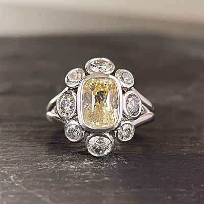 'Moon River' Platinum ring, 2.10CT cushion yellow sapphire bezel with 1.26TCW grey round brilliant diamond halo. Ring size 6.5