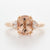 Three stone rose gold engagement ring featuring a cushion cut Morganite centre stone flanked by brilliant cut diamonds.