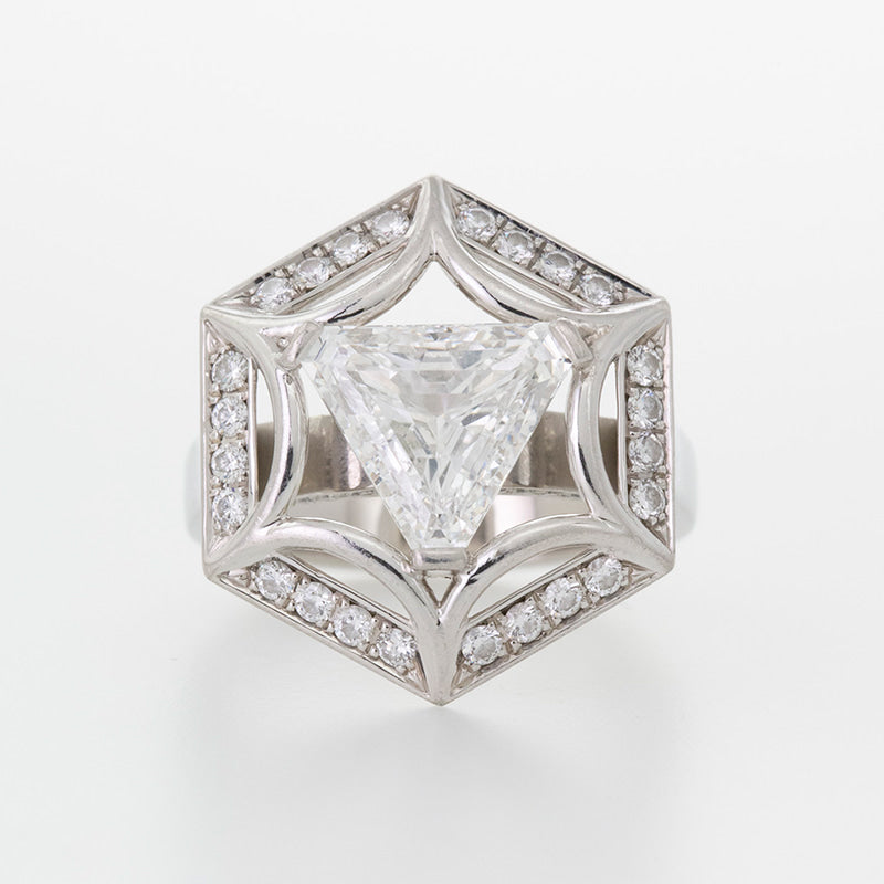 Trilliant cut diamond centre stone with hexigonal diamond halo set in Platinum. Custom made cocktail/engagement ring.